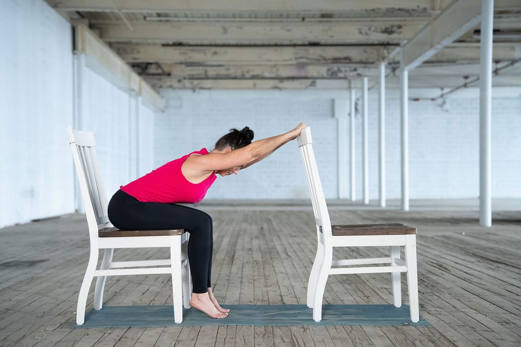 Yoga instructor Jane Hart shows a modified pose using two chairs