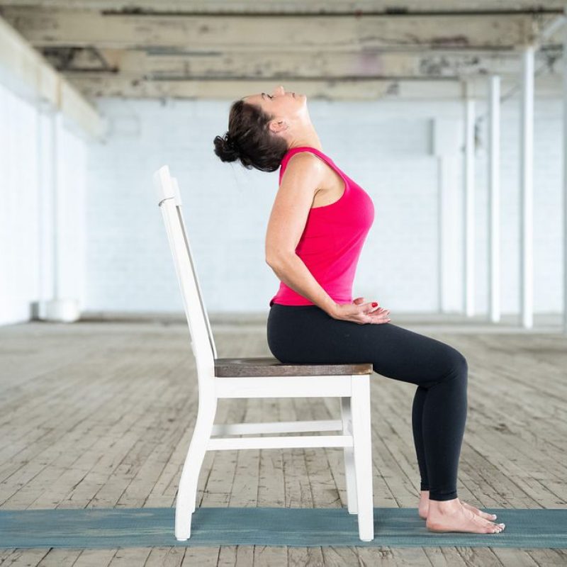 Modified Ability Yoga Instructor Jane Hart of Greenville, SC shows a cat cow adapted pose in a chair
